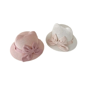 Pink and beige baby straw hats with bow decoration and breathable woven texture