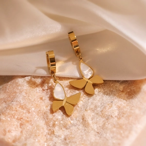 Gold-plated butterfly earrings with white shell inlay on silk and pink stone backdrop