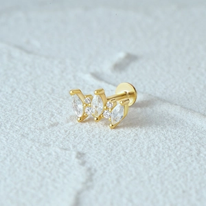 Macro detail of gold S925 silver flat back ear stud with marquise clear crystals