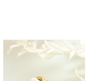 Close-up of golden U-shaped earrings with a twisted geometric design and polished finish