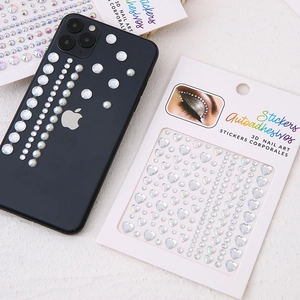 3D heart rhinestones and pearl body stickers displayed with a mobile phone for DIY face art