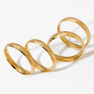 Set of 4 vintage stainless steel wide bracelets with floral engraving in gold finish