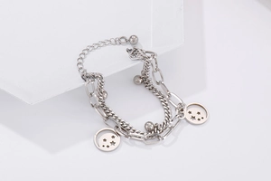 Detail of silver double-layer stainless steel bracelet with hollow star charms and beads