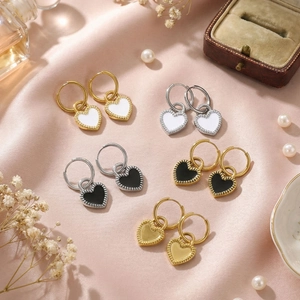 Detail showing five pairs of heart-shaped hoop earrings in gold and silver finishes