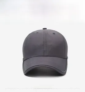 Close-up of the front embroidery and durable curved brim on this dark gray sports cap