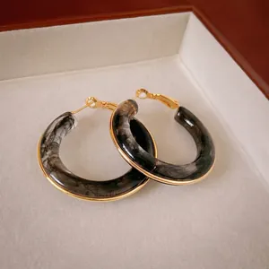 Golden plated hollow hoop earrings with dark marble resin texture in vintage style