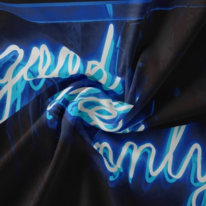 Detailed view of the soft textile fabric with neon blue good vibes only lettering