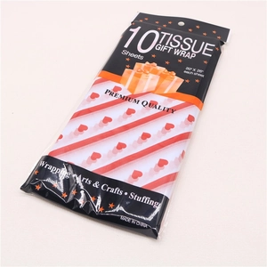 Detail of premium red and white striped tissue gift wrap with heart patterns, 10 sheets pack