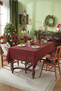 Close-up of festive red and green plaid tablecloth with tassel edges for Christmas dining
