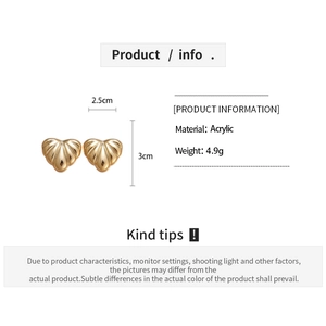 Detail view of heart-shaped acrylic earrings with striped pattern and size measurements