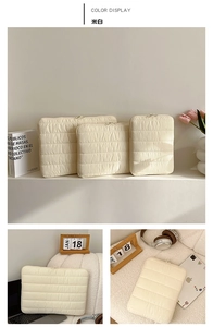 Detailed close-up of off-white quilted shockproof laptop sleeves in three sizes