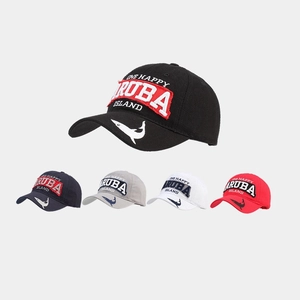 Detail of embroidered cotton golf caps with shark motif and Aruba Island lettering