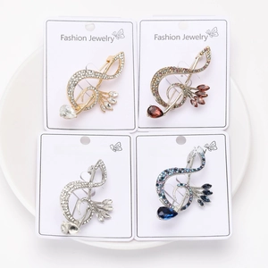 Detailed view of alloy musical note brooches with inlaid rhinestones and colorful crystals