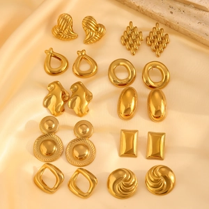 Set of minimalist 18K gold plated irregular stainless steel earrings on silk background