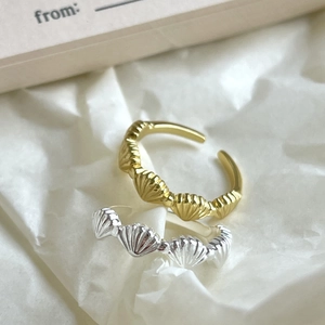 Minimalist 925 sterling silver shell style rings in gold and silver finish on white paper