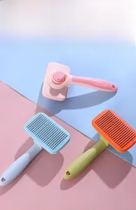 Three long-handle pet grooming brushes with self-cleaning buttons in multiple colors