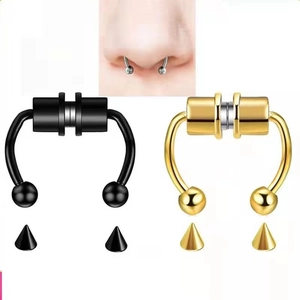 Detail of magnetic fake septum rings in black and gold with interchangeable spiked studs