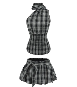 Close-up of black and white checkered halter top and skirt set with waist bow detail