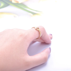 Detail of adjustable gold moon ring with chain band design worn on finger