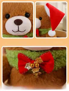 Close-up of Christmas teddy bear showing festive red hat and green scarf with gold bell