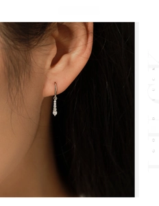 Macro shot of elegant S925 silver water drop earrings with shimmering VVS1 moissanite stones
