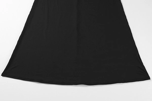 Close-up of the double-stitched hem and fabric texture on a black bodycon mesh dress