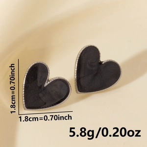 Detail view of 304 stainless steel heart earrings with black matte finish and silver edges