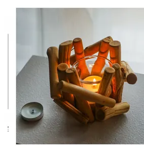 Detailed view of handcrafted driftwood candle holder with lit tealight in glass cup