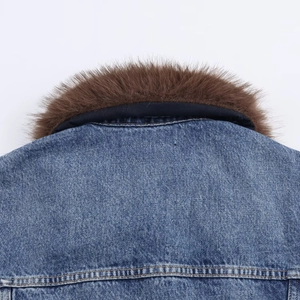 Macro detail of blue denim jacket with brown faux fur collar and stitching