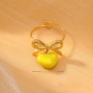 Detailed size view of gold bow ring with heart charm and weight specifications