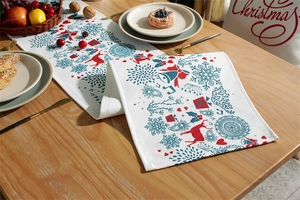 Detailed pattern of festive Christmas table runner with reindeer and snowflakes on fabric