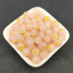 Close-up of 8mm frosted glass beads in pink and yellow colors for DIY jewelry making