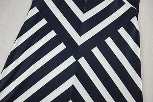 Detailed close-up of the black and white geometric stripe pattern and sewing on the dress