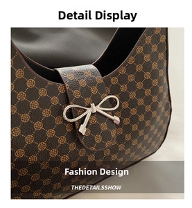 Detail of dark brown crescent bag with gold clover pattern and silver bow buckle