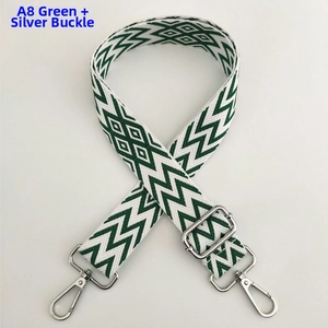 Detail of green and white wave patterned wide adjustable bag strap with silver metal buckles