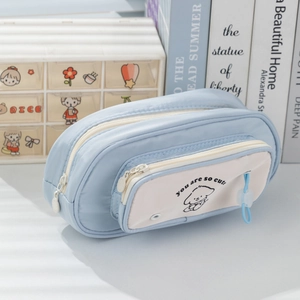 Macro shot of large capacity light blue multi-layer pencil case with cute puppy print