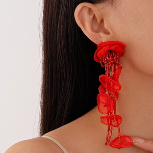 Detail of red handmade lace flower tassel earrings featuring intricate beadwork