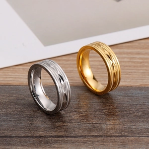 Detailed macro shot of gold and silver titanium steel rings with geometric textures
