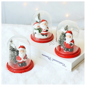 Macro detail of Christmas glass globes with Santa Claus, snowmen and warm lighting decor