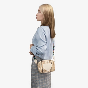 Straw camera bag with heart patch and colorful LOVE letter shoulder strap on model