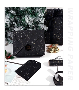 Black Christmas wrapping paper with gold and silver glitter foil on festive gift boxes