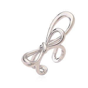 Detailed view of silver bow-shaped open ring featuring polished metal and fluid lines