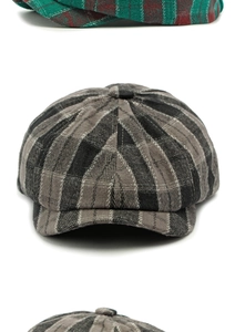 Close-up of grey plaid wool newsboy cap showing detailed textured fabric and button