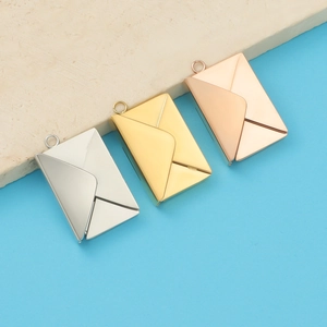 Detailed view of envelope pendants in silver, gold, and rose gold stainless steel