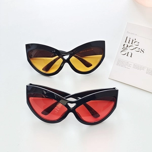 Detail view of oversized cat-eye sunglasses with unique heart-shaped cutout on the bridge