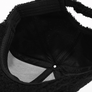 Detail view of the black lamb wool baseball cap featuring breathable mesh lining and stitching