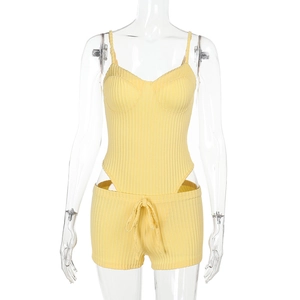 Detail of yellow knitted two-piece set featuring striped texture and drawstring shorts
