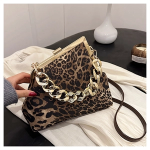 Detail of leopard print shell bag with chunky gold chain and vintage metal frame clasp