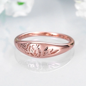 Macro shot of rose gold plated S925 silver ring featuring intricate floral relief patterns