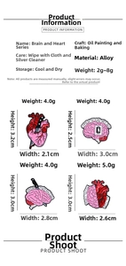 Detailed view of brain and heart anatomical enamel pins with sizes and weight specs